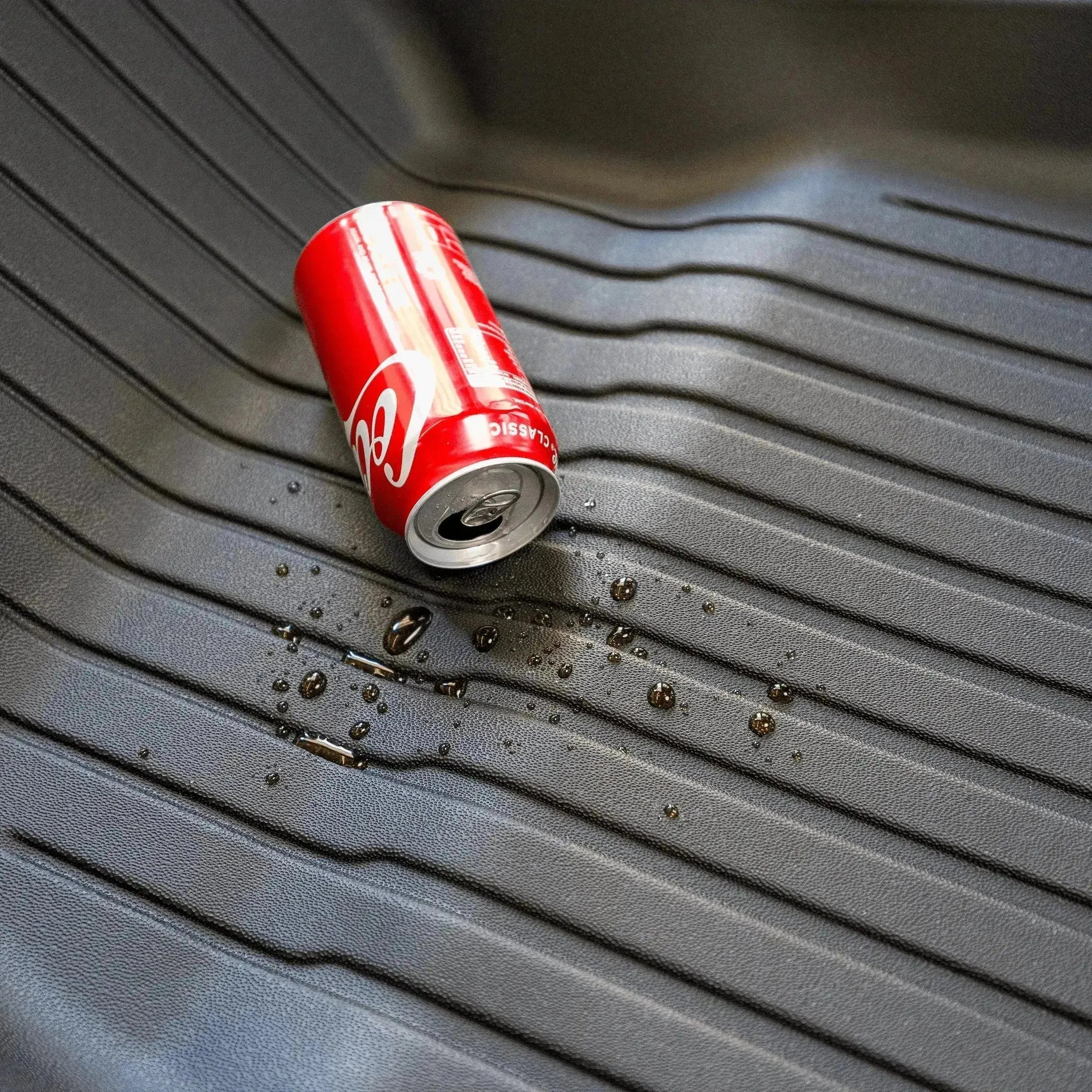 A can of coke spilled out on the TPE material waterproof floor mat. A can of coke spilled out on the TPE material waterproof floor mat.