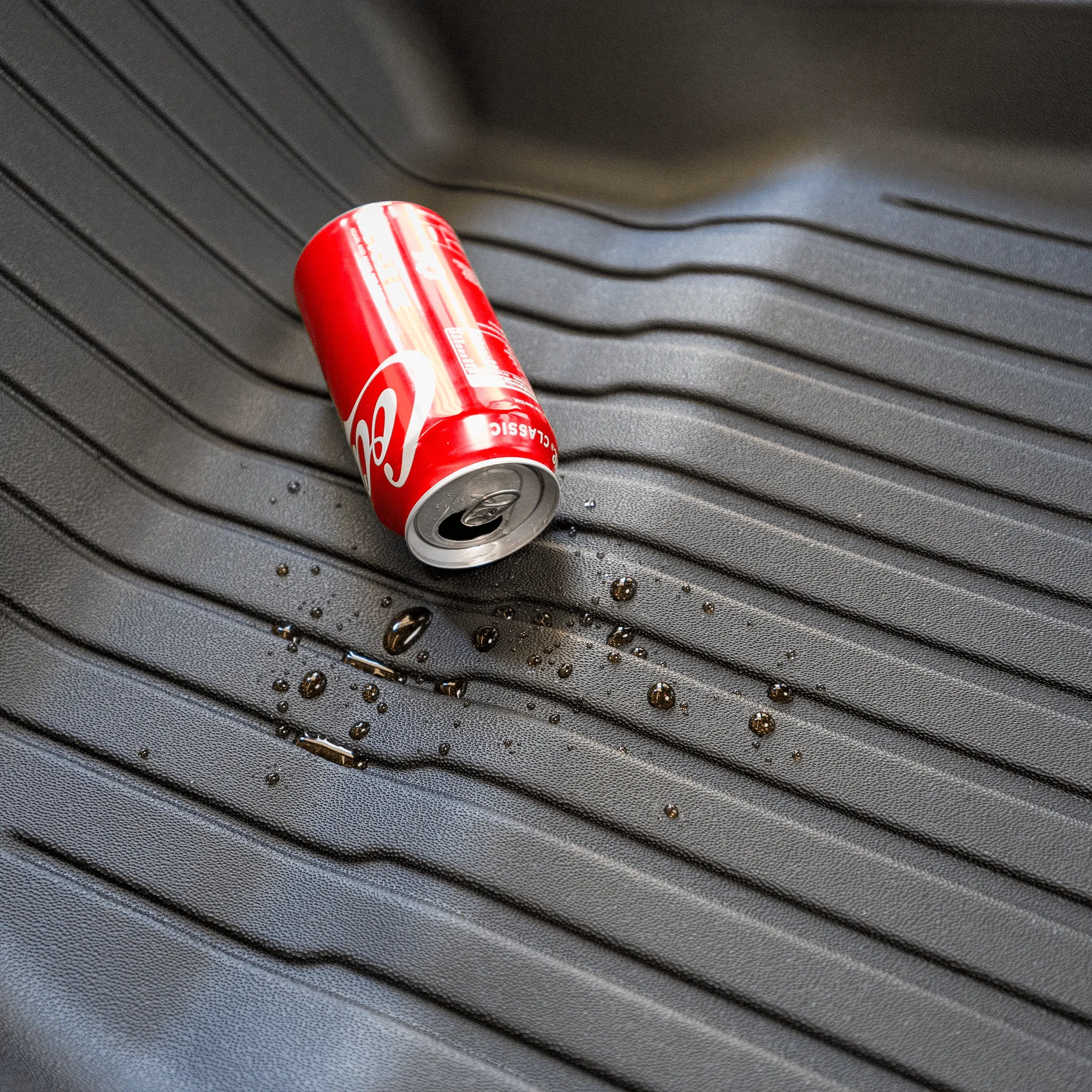 A can of coke spilled out on the TPE material waterproof floor mat.